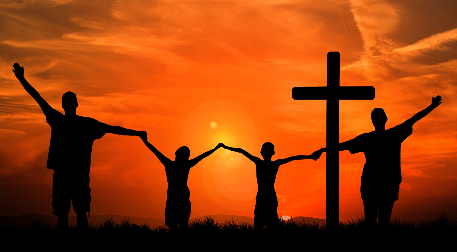 4 people holding hands near a cross