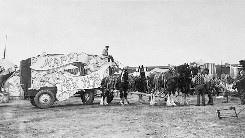 Photo: Ringling Brothers horse-drawn circus wagon with “Happy New Year” displayed on the side of the wagon, circa 1932, public domain, via Wikimedia.